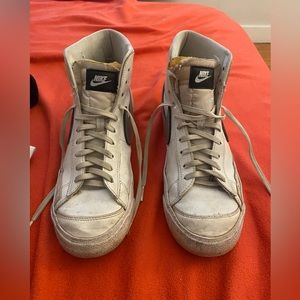 pair of nike blazers with silver nike logo